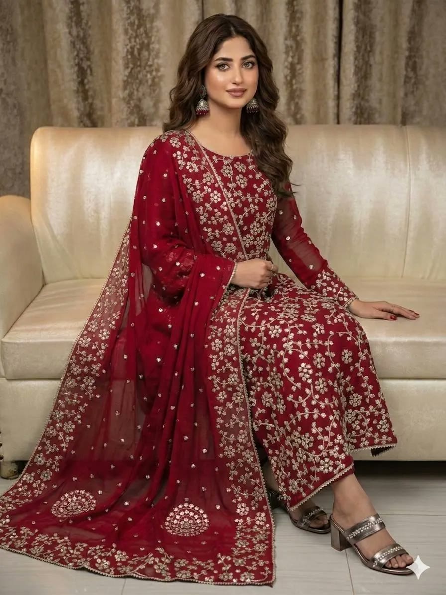 Woman wearing a hand-embroidered red Pakistani outfit with gota work